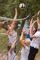 Image showing group of young friends playing Beach volleyball