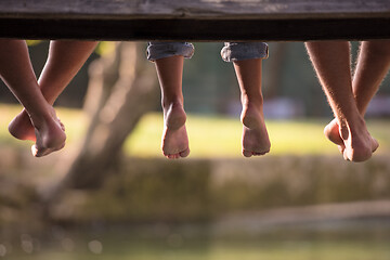 Image showing people sitting at wooden bridge