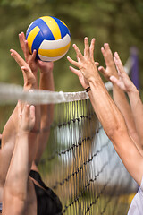 Image showing group of young friends playing Beach volleyball