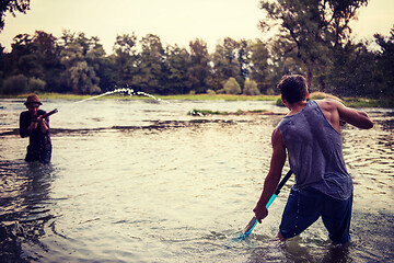 Image showing young men having fun with water guns