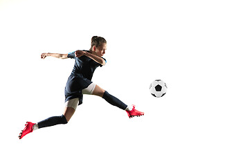 Image showing Female soccer player kicking ball isolated over white background