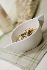 Image showing bowl full of musli and bottle of milk