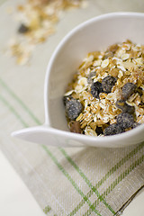 Image showing bowl full of musli and bottle of milk