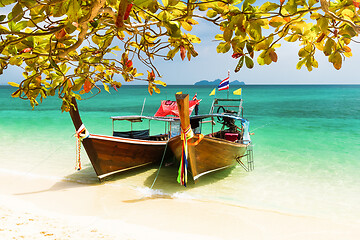 Image showing Traditional wooden long tail boats on a picture perfect tropical beach near Phuket, Thailand, Asia