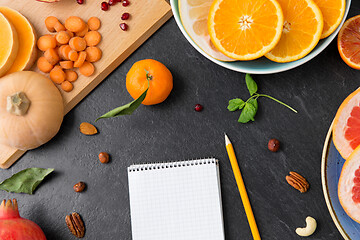 Image showing close up of notebook, fruits and vegetables