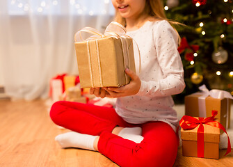 Image showing close up of girl with christmas gift at home