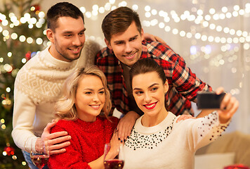 Image showing friends taking selfie at christmas dinner