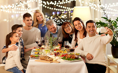 Image showing family having dinner party and taking selfie