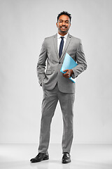 Image showing indian businessman with folder over grey