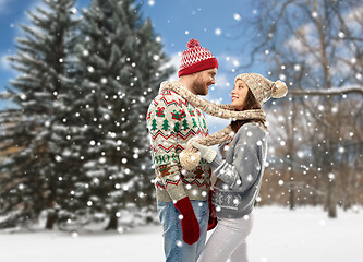 Image showing couple in christmas ugly sweaters at winter park
