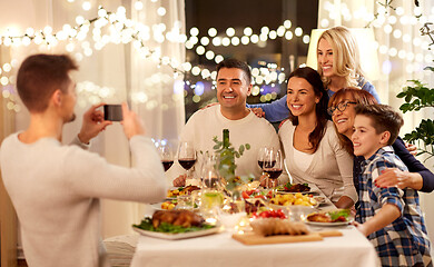 Image showing family having dinner party and taking selfie