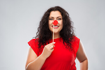 Image showing happy woman with red clown nose posing