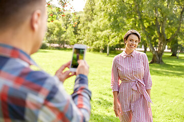 Image showing couple photographing by smartphone in park