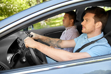 Image showing car driving school instructor and male driver