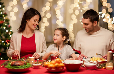 Image showing happy family having christmas dinner at home