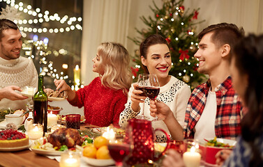 Image showing happy friends having christmas dinner at home