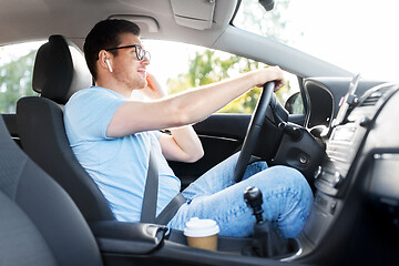 Image showing man or driver with wireless earphone driving car