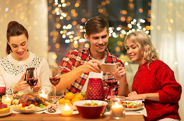 Image showing happy friends having christmas dinner at home