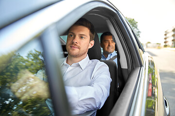 Image showing male driver driving car with passenger