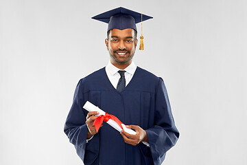 Image showing male graduate student in mortar board with diploma