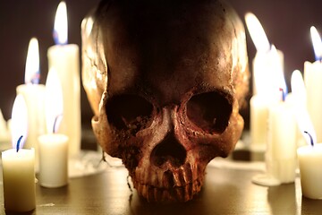 Image showing Human skull against dark background in candle light closeup