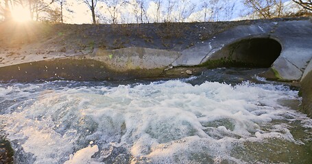 Image showing Large sewage tunnel with filth flowing out