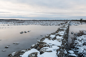 Image showing Dry stone wall in a flooded grassland