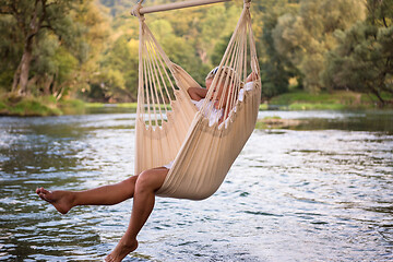 Image showing blonde woman resting on hammock