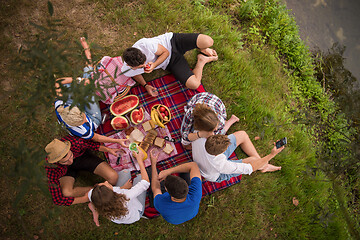 Image showing top view of group friends enjoying picnic time