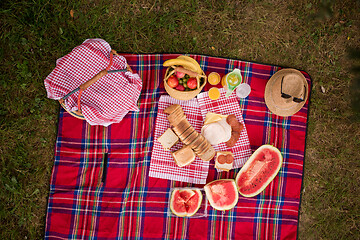 Image showing top view of picnic blanket setting on the grass