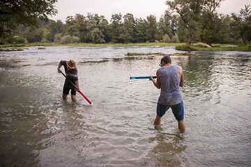 Image showing young men having fun with water guns