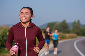 Image showing young people jogging on country road