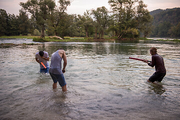 Image showing young men having fun with water guns