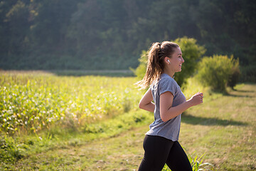 Image showing woman jogging along a country road