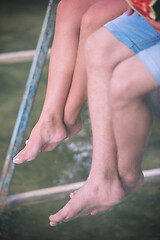 Image showing people sitting at wooden bridge