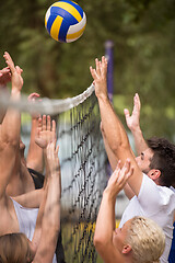 Image showing group of young friends playing Beach volleyball