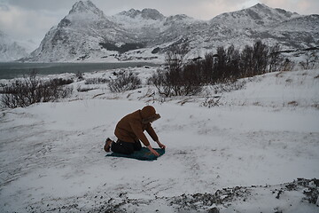 Image showing Muslim traveler praying in cold snowy winter day