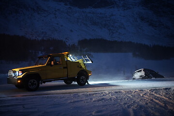 Image showing Car being towed after accident in snow storm