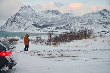 Image showing Muslim traveler praying in cold snowy winter day