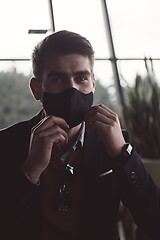 Image showing business man wearing protective face mask at luxury office