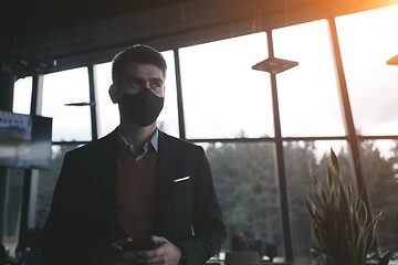 Image showing business man wearing protective face mask at luxury office