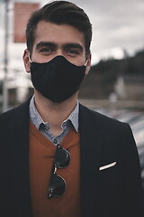 Image showing business man wearing protective face mask at luxury office