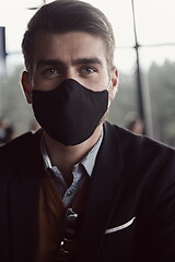 Image showing business man wearing protective face mask at luxury office