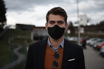 Image showing business man wearing protective face mask at luxury office