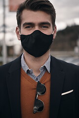 Image showing business man wearing protective face mask at luxury office