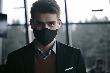 Image showing business man wearing protective face mask at luxury office