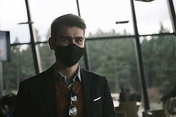 Image showing business man wearing protective face mask at luxury office