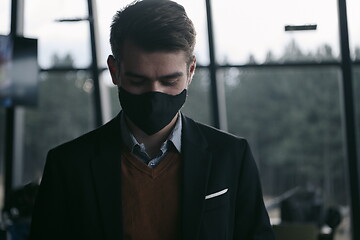 Image showing business man wearing protective face mask at luxury office