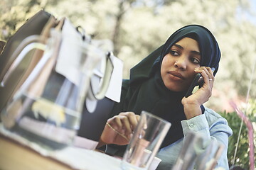 Image showing african woman using smartphone wearing traditional islamic clothes