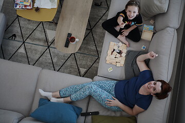 Image showing mother and daughter at home playing memory game